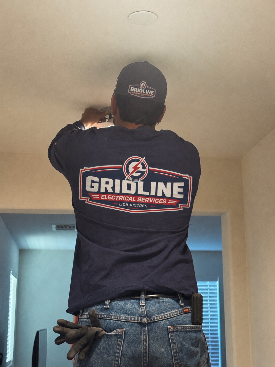 Gridline electrician installing residential lighting