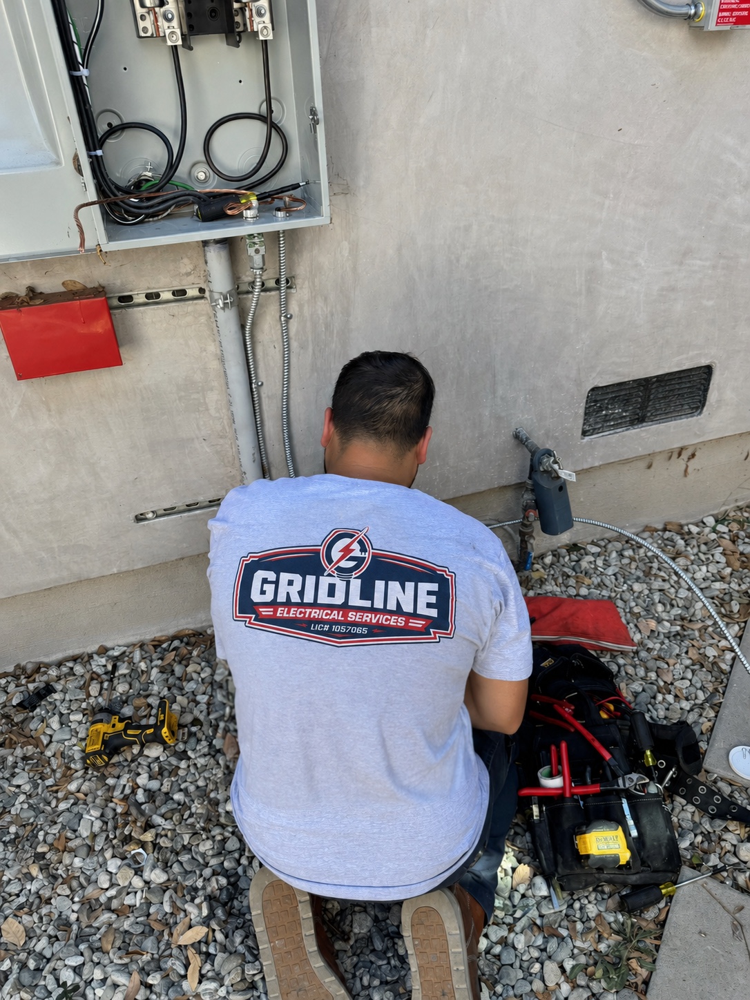 Gridline electrician servicing an electrical panel