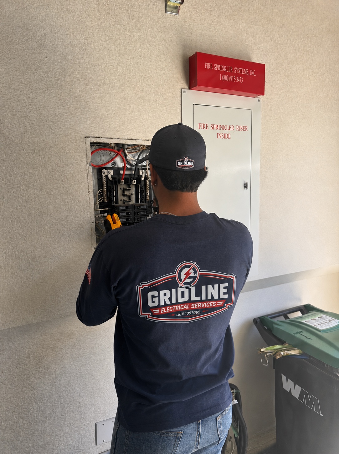 Gridline electrician troubleshooting electrical equipment